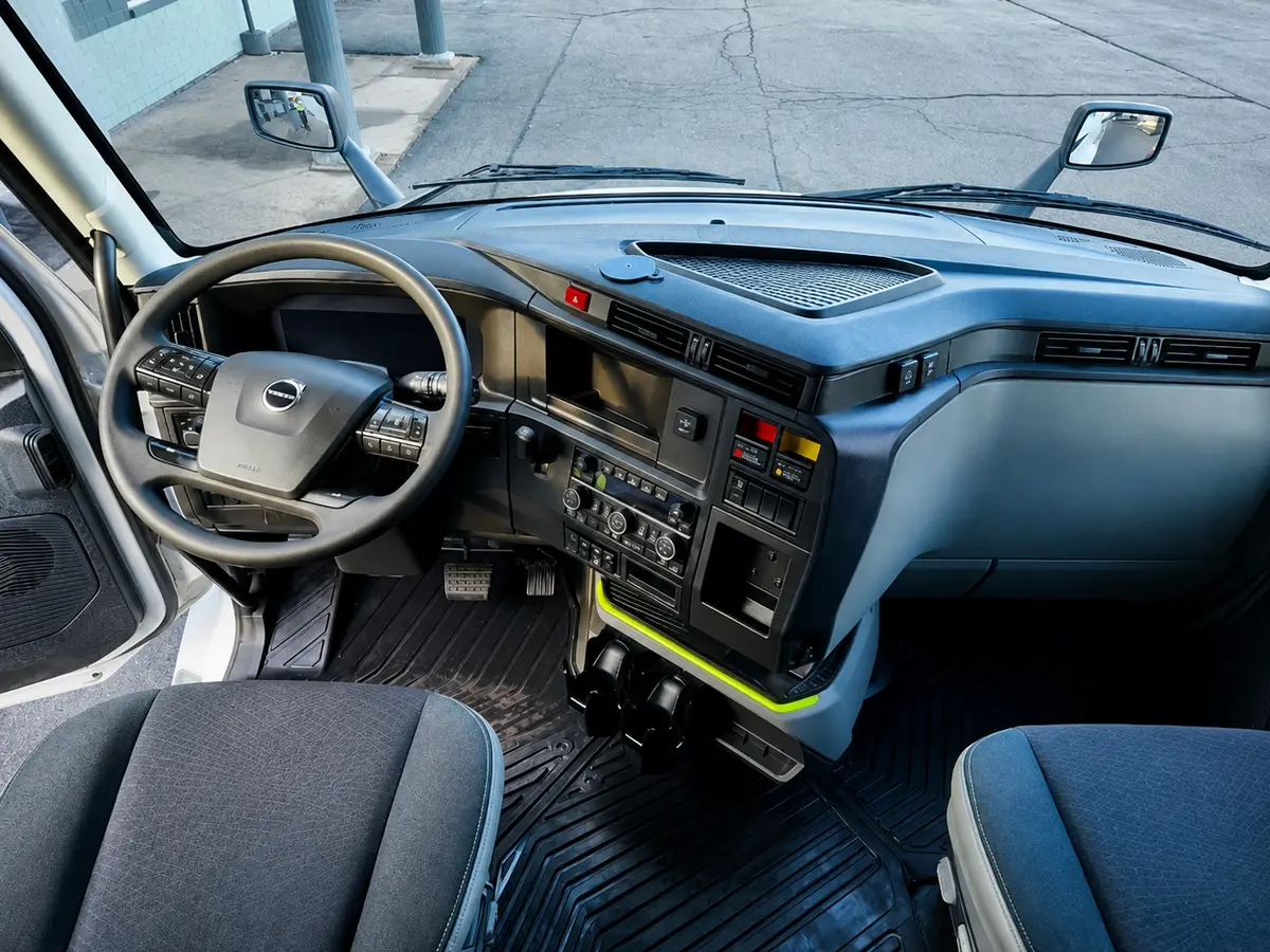 Interior of a semi-truck cab showing the steering wheel and dashboard